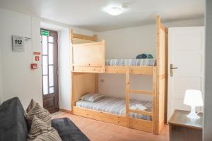 a living room with two bunk beds and a couch at Estúdios Lagido - Peniche Surf Camp Working Space & surf in Ferrel