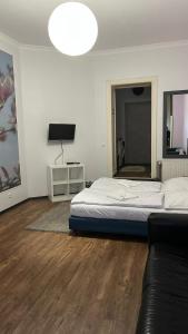 a bedroom with a bed and a tv and a couch at Albert rooms in Berlin