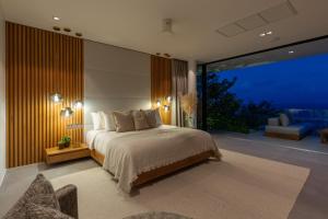 a bedroom with a large bed and a large window at Villa Amylia Emerald, design excellence in Koh Samui +72 photos