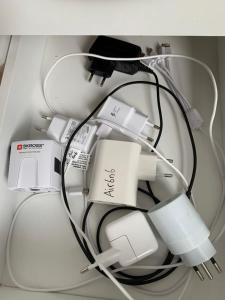 a pile of nintendo wii controllers and chargers at Wohnung in Bern