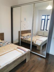 a room with two beds and a mirror at Great Black Sea View in Constanţa