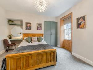 - une chambre avec un lit en bois et un miroir dans l'établissement Grosvenor House, à Alnwick