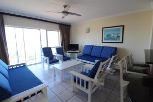 ein Wohnzimmer mit blauen Stühlen und einem Tisch in der Unterkunft Santana 406 in Margate