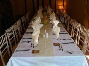 a long table with napkins and utensils on it at The George in Bridgnorth