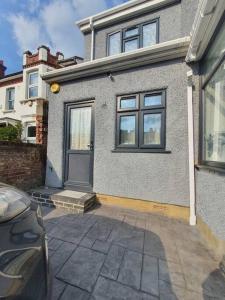 a house with a door and a car in front of it at Studio in London with free parking on premises in Thornton Heath