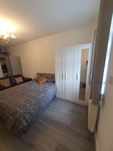 a bedroom with a bed and a sliding door at Studio in London with free parking on premises in Thornton Heath