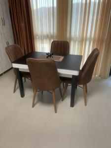 a dining room table and chairs in a room at Hillside Bakuriani in Bakuriani
