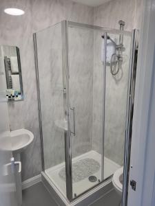 a shower stall in a bathroom with a sink at The Bird in Hand in Stourport