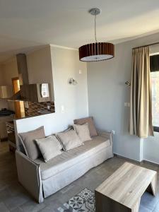a living room with a couch and a table at Kimiro Drosia Zante in Psarou +70 photos