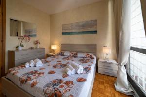 a bedroom with a bed with towels on it at ISEO CHARME VILLAS in Iseo