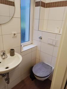 a bathroom with a toilet and a sink at Albert rooms in Berlin