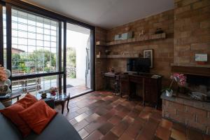a living room with a couch and a television at ISEO CHARME VILLAS in Iseo
