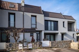 a house with a stone fence in front of it at ISEO CHARME VILLAS in Iseo