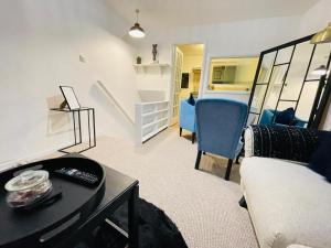 a living room with a couch and a table at Lovely 1 Bed home near Hospital, with Parking & Garden WORK CONTRACTOR LEISURE, SAPPHIRE in Cherry Hinton