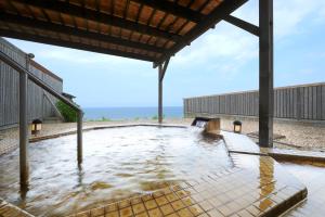 a large pool of water on a beach at Hotel Grand Mer Sankaiso in Ajigasawa
