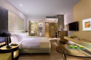 a hotel room with a bed and a living room at Holiday Inn New Delhi International Airport, an IHG Hotel in New Delhi