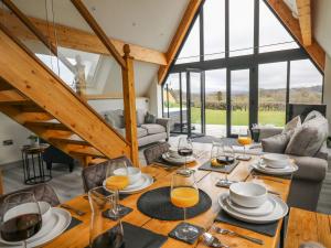 a dining room with a table with glasses of orange juice at Hill Radnor - The Sheepfold in Llandrindod Wells