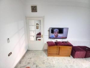 a living room with a couch and a flat screen tv at Abdoun ground floor apartment in Amman
