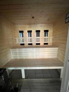 a sauna with three windows and a bench in it at Wellness apartman in Siófok