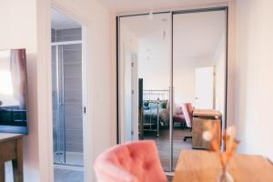 a glass door leading into a living room with a table at Oakley Place - Room A Deluxe Ensuite in Bristol