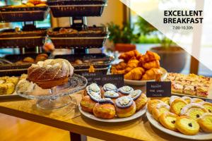 a bakery with different types of pastries on a counter at Plaza Prague Hotel - Czech Leading Hotels in Prague