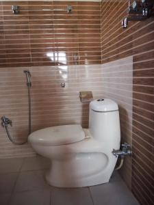 a bathroom with a toilet and a shower at The Nest Guest House in Changunarayan