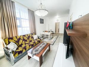 a living room with a couch and a table at Hotel ZeraVictoria in Atyraū