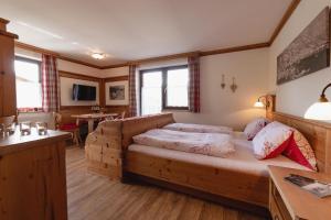 a bedroom with a large wooden bed in a room at Feldinggut in Bad Hofgastein