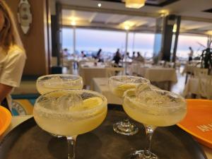 a group of margaritas in glasses on a tray at Villa Arberia in Durrës