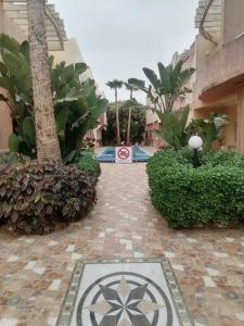 a walkway leading to a building with a sign on it at Sidi bouzid in Douar Zeraoula