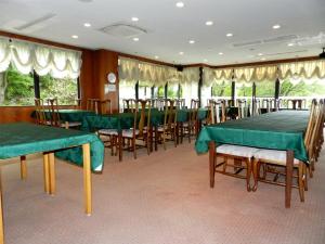 藏王溫泉的住宿－藏王溫泉酒店，用餐室配有绿色的桌椅