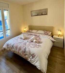a bedroom with a large bed with two lamps at Apartment in Salou next to the beach for families,WIFI in Salou