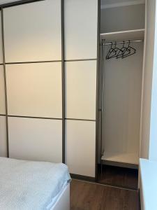 a bedroom with a bed and a closet at Alunana Suites in Rīga