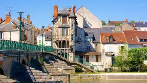 a bridge over a river in a city with buildings at Little Factory - T2 avec parking in Vierzon