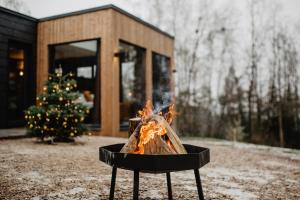 a fire pit with a christmas tree in front of a house at Atokampis Boutique SPA & Resort 