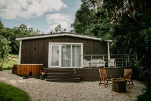 a small cabin with two chairs and a porch at Atokampis Boutique SPA & Resort 