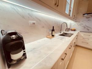 a kitchen counter with a blender and a bottle of wine at Villa Azure in Palasë