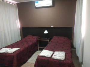 מיטה או מיטות בחדר ב-Cabañas Bella Alba
