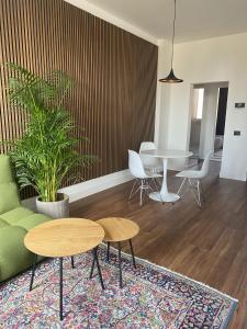 a living room with two tables and a table and chairs at LOFT MANZONI 37 in Cremona
