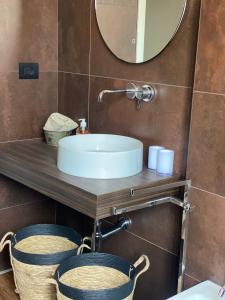 a bathroom with a sink and a mirror at LOFT MANZONI 37 in Cremona +45 photos