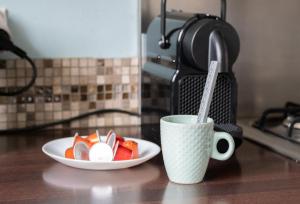 une assiette de fruits et une tasse de café sur un comptoir dans l'établissement Maison - Le Terra Verde - Terrasse, à Haguenau