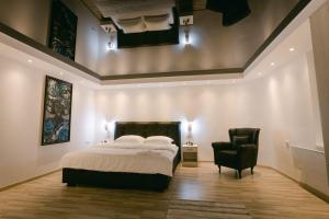 a bedroom with a large bed and a chair at Backa idila in Bački Gračac +108 photos