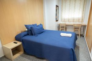 Postel nebo postele na pokoji v ubytování Hostal Mitre Paterna