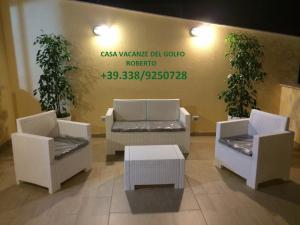 a lobby with chairs and a table and a sign at Casa Vacanze del Golfo in Castellammare del Golfo
