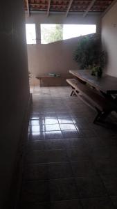 a room with a bench and a table on a tile floor at Guest Hostel 2 Marli's in Bonito