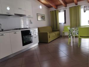 a kitchen and living room with a couch and a table at Casa Vacanze del Golfo in Castellammare del Golfo
