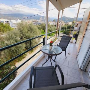 a table and chairs on a balcony with a view at Luxury Loft Apartment Sofia in Patra