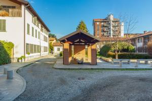 a building with a pavilion in the middle of a street at Cozy Flat 500m from Affori FN! in Milan