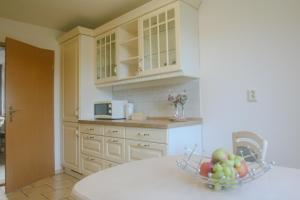 a kitchen with a bowl of fruit on a table at Ferienhaus Bomeier in Wernigerode +11 photos