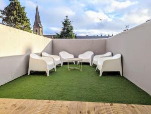 a group of chairs and a table on a balcony at Ramsgate Retreat - ultra modern 3 bed in Ramsgate